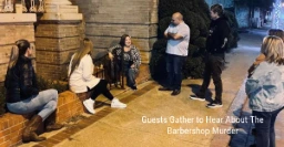 Guests listening to the haunted barbershop murder mystery during a 90-minute guided ghost tour in historic downtown Terrell.