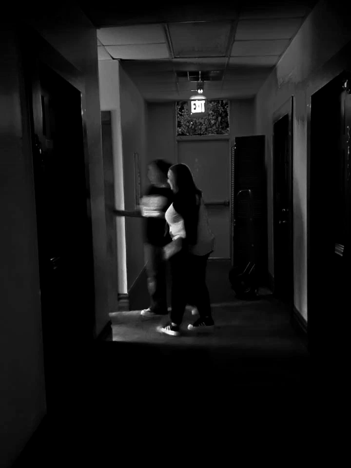 Tour group investigating paranormal activity and phantom noises inside a historic haunted building in Terrell, Texas.